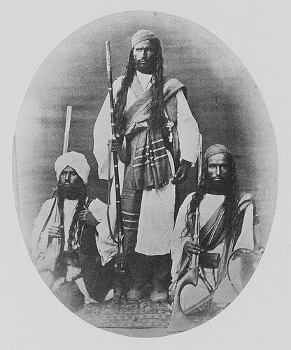 Portrait_of_three_unknown_men_of_Brahui_descent_with_weapons_Brahooees._Inhabitants_of_Khelat_state._Soonnee_Mahome_Dance._Sind
